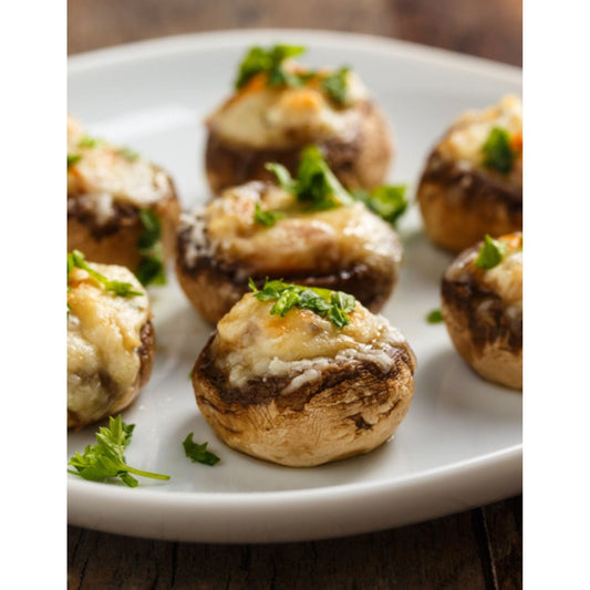 A plate of stuffed mushrooms, a delectable appetizer with a savory filling, served as a mouthwatering dish.