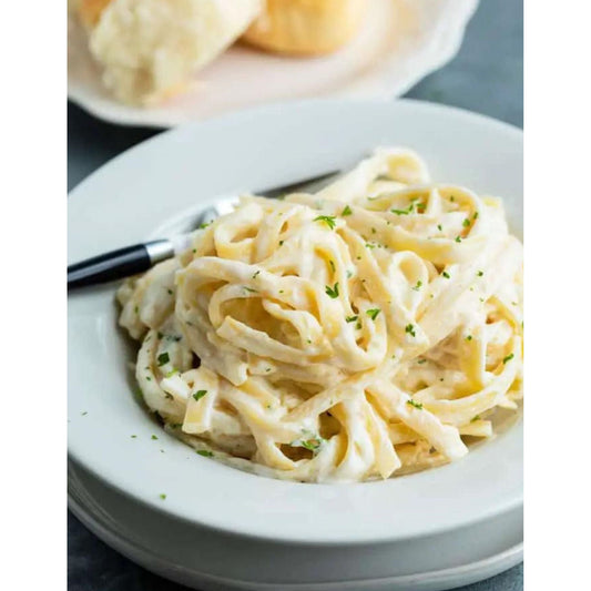 Creamy Alfredo Sauce over pasta for a simple, delicious meal.