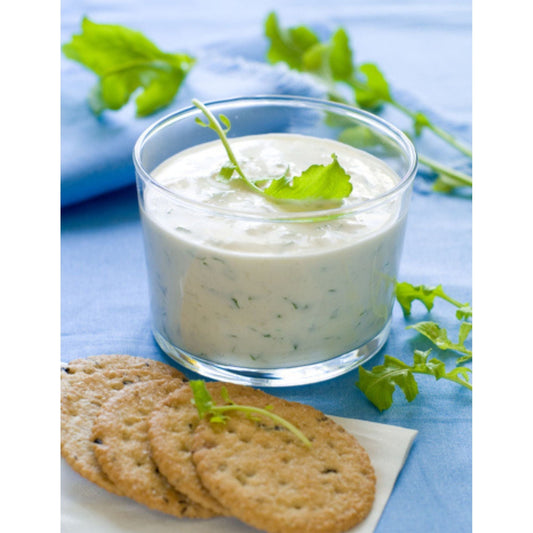 A bowl of garlic dip surrounded by crackers