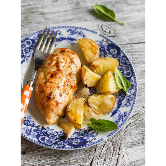 A plate with garlic chicken and potatoes, a delicious and savory meal.