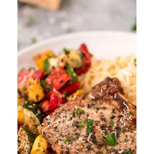 Flavorful, tender pork chops with onions, peppers, squash, zucchini with our seasoning. Simple to make sheet pan meal.