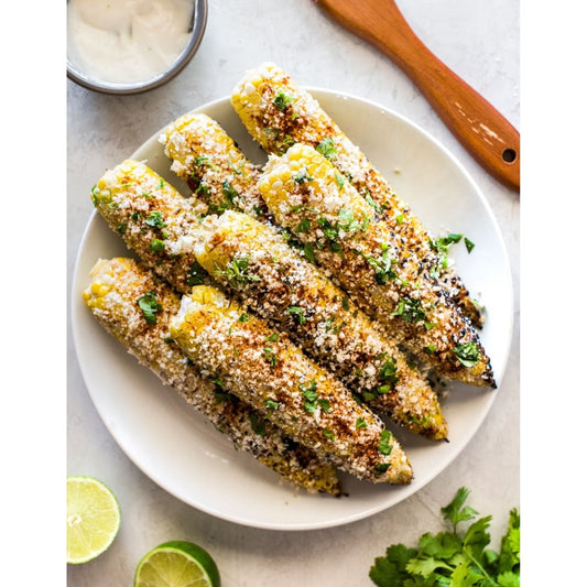 Grilled Mexican corn on the cob topped with cilantro and lime. Mexican Street Corn.