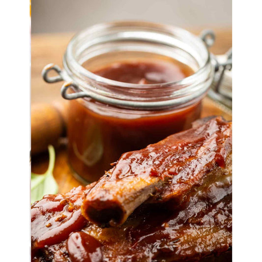 Delicious BBQ sauce drizzled over succulent ribs, creating a mouthwatering combination.