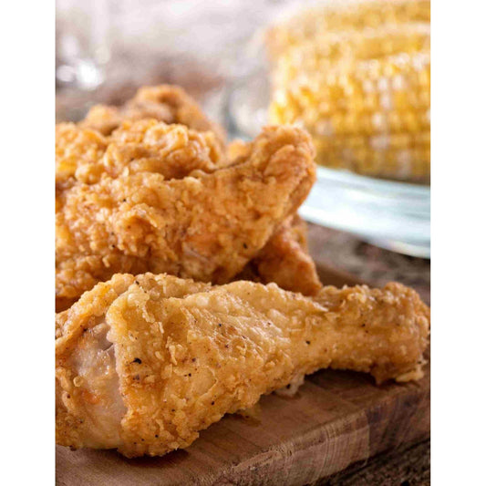 A delicious plate of oven fried chicken and corn on the cob.