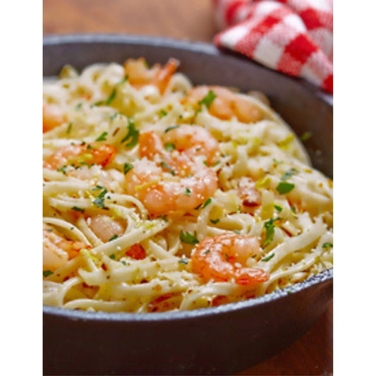 A skillet filled with shrimp scampi pasta, a delicious dish with succulent shrimp and flavorful pasta.